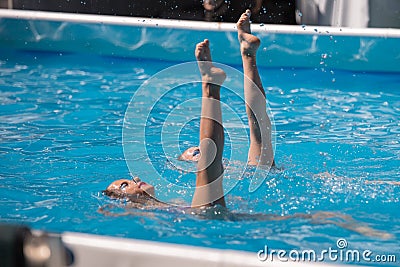 Performing Artistic Duet in Swimming Pool: Synchronized Swimming during Exercise Editorial Stock Photo