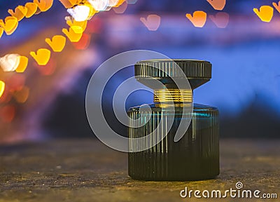 Perfume bottle on the background of colorful bokeh Stock Photo