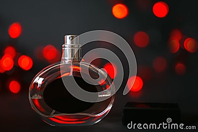 Perfume bottle on a black background with red lights Stock Photo