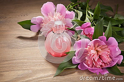 Perfume bottle and flowers on old boards Stock Photo