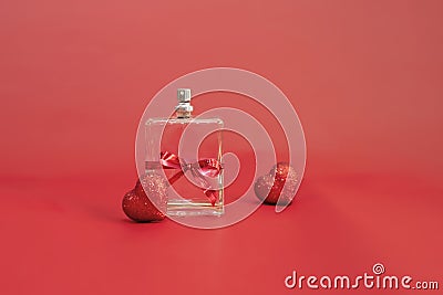 perfume bottle tied with a red festive ribbon among red hearts on a red background,selective focus. Gift card for Stock Photo