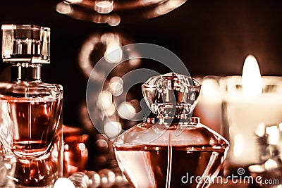 Perfume bottle and vintage fragrance on glamour vanity table at night, pearls jewellery and eau de parfum as holiday gift, luxury Stock Photo