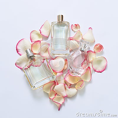 Perfume bottles with flower petals on light background. Perfumery, fragrance collection. Women accessories. Stock Photo