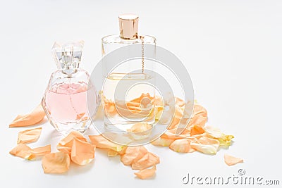 Perfume bottles with flower petals on light background. Perfumery, fragrance collection. Women accessories. Stock Photo