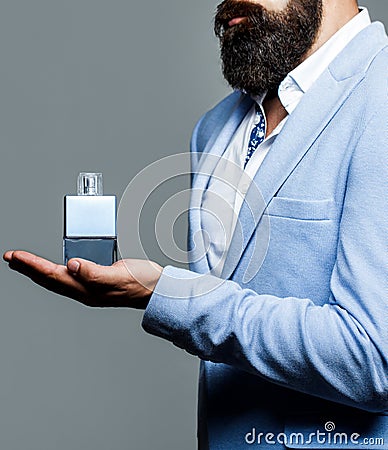 Perfume or cologne bottle, perfumery, cosmetics, scent cologne bottle, male holding cologne. Masculine perfumery Stock Photo