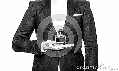 Perfume or cologne bottle and perfumery, cosmetics, scent cologne bottle, male holding cologne. an in a suit holding a Stock Photo