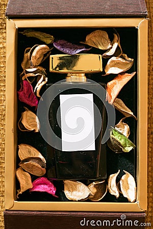 Perfume glass bottle inside golden gift box Stock Photo