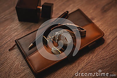 Perfume with watch and notepad Stock Photo