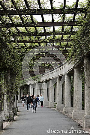 A pergola in Wroclaw, people are resting while walking along a corridor made of columns Editorial Stock Photo