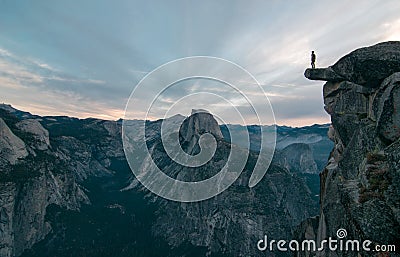 Perhaps the best view of glacier point where this unknown adventurer dares to stand on the edge Stock Photo
