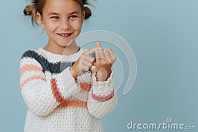 Perky little girl in striped sweater counting on her fingers over blue Stock Photo