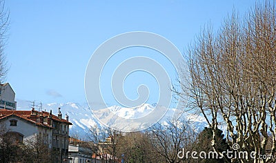Perpignan. Panorama top view. Tiled roofs of houses and mountains with snowy peaks in the distance. Spring. 2009. France. Stock Photo