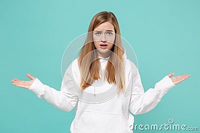 Perplexed worried young woman girl in casual white hoodie posing isolated on blue turquoise wall background studio Stock Photo