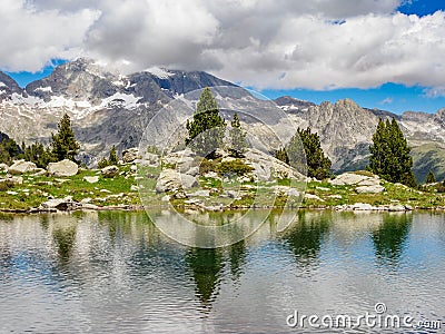 Perramo lake and Perdiguero peak at baclground in Benasque Valley, Spain Stock Photo