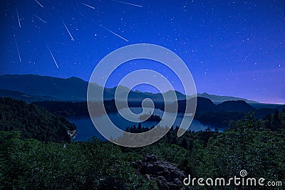 Perseid MEteor Shower over Bled Lake at Starry Dark Night in Summer Stock Photo