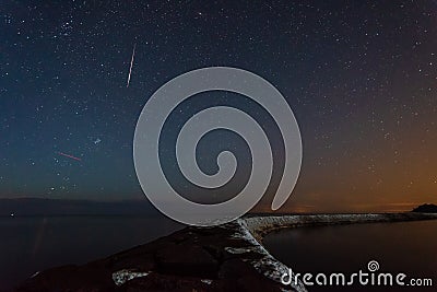 Perseids meteor shower of the 2021 in the sky over the Ladoga lake, Russia Stock Photo