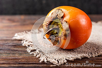 Persimmon on dark wooden background Stock Photo