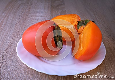 persimmon fruit, close ripe fruits on a plate Stock Photo