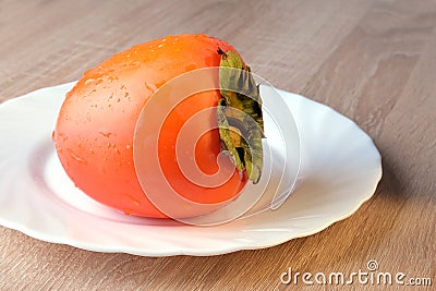 Persimmon fruit, close ripe fruits on a plate Stock Photo