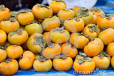 Persimmon Fruits on shelve in fruit market Stock Photo