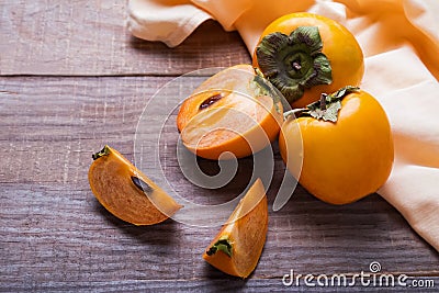 Persimmon fruits on the wooden table Stock Photo