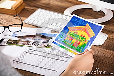 Person Analyzing The Thermal Image Of A House Stock Photo