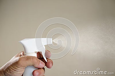 Person applying alcohol spray for hygiene Stock Photo