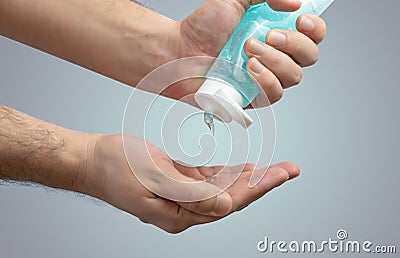 Person applying hand sanitiser gel to kill bacteria and disease - Close up of hands washing and cleansing with hygienic Stock Photo