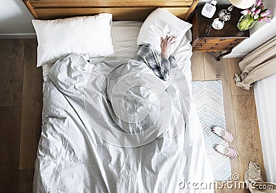 Person on bed insomnia and noise pollution concept Stock Photo