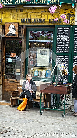 Shakespeare and Company book shop in Paris person browsing Editorial Stock Photo