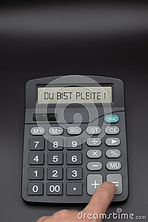 person calculates with calculator his money and assets and gets displayed in german you are broke Stock Photo