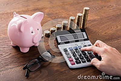 Person Calculating Savings On Calculator Stock Photo