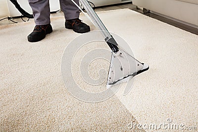 Person Cleaning Carpet With Vacuum Cleaner Stock Photo