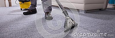 Person Cleaning Carpet With Vacuum Cleaner Stock Photo