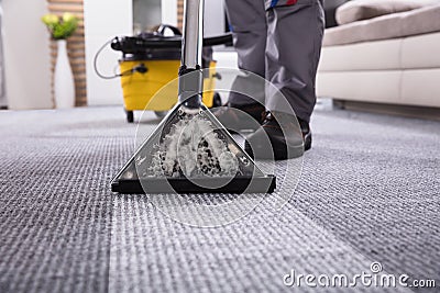 Person Cleaning Carpet With Vacuum Cleaner Stock Photo