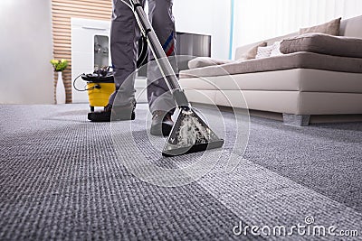 Person Cleaning Carpet With Vacuum Cleaner Stock Photo