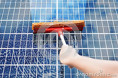 Person Cleaning Solar Panel Stock Photo