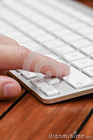 A person clicking button on computer keyboard Stock Photo