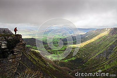 Person on cliff of mountain Stock Photo