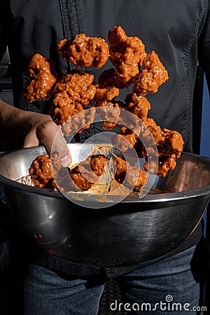 Person cooking some delicious boneless with buffalo sauce Stock Photo