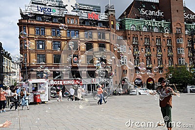 Person creats soap bubbles and people enjoy bubbles in Copenhagen Editorial Stock Photo
