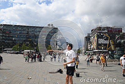 Person creats soap bubbles and people enjoy bubbles in Copenhagen Editorial Stock Photo