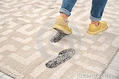 Person in dirty shoes leaving muddy footprints Stock Photo