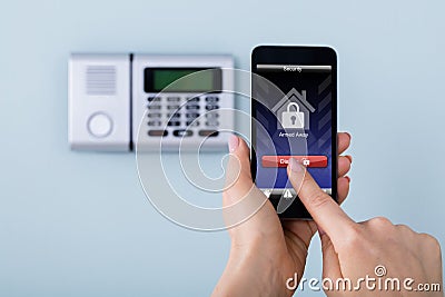 Person Disarming The System With Remote Controller Stock Photo