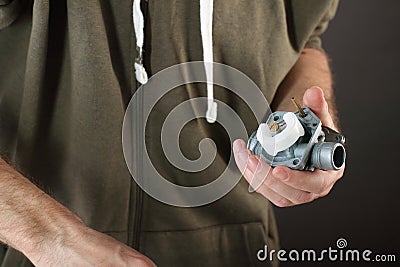 Person disassembling the carburetor Stock Photo