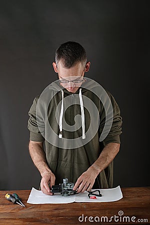 Person disassembling a scooter carburetor Stock Photo