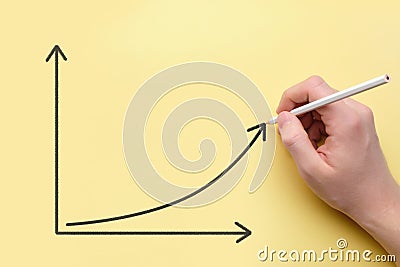 Person draws a graph of growth with a pencil. Success concept Stock Photo