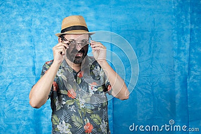 Person dressed as a tourist in a blue background Stock Photo