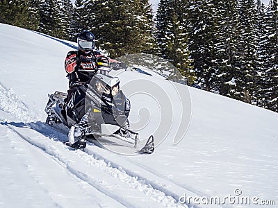 The person driving the snowmobile Editorial Stock Photo