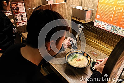 Person eating Ichiran Ramen resturant at Osaka, Japan Editorial Stock Photo